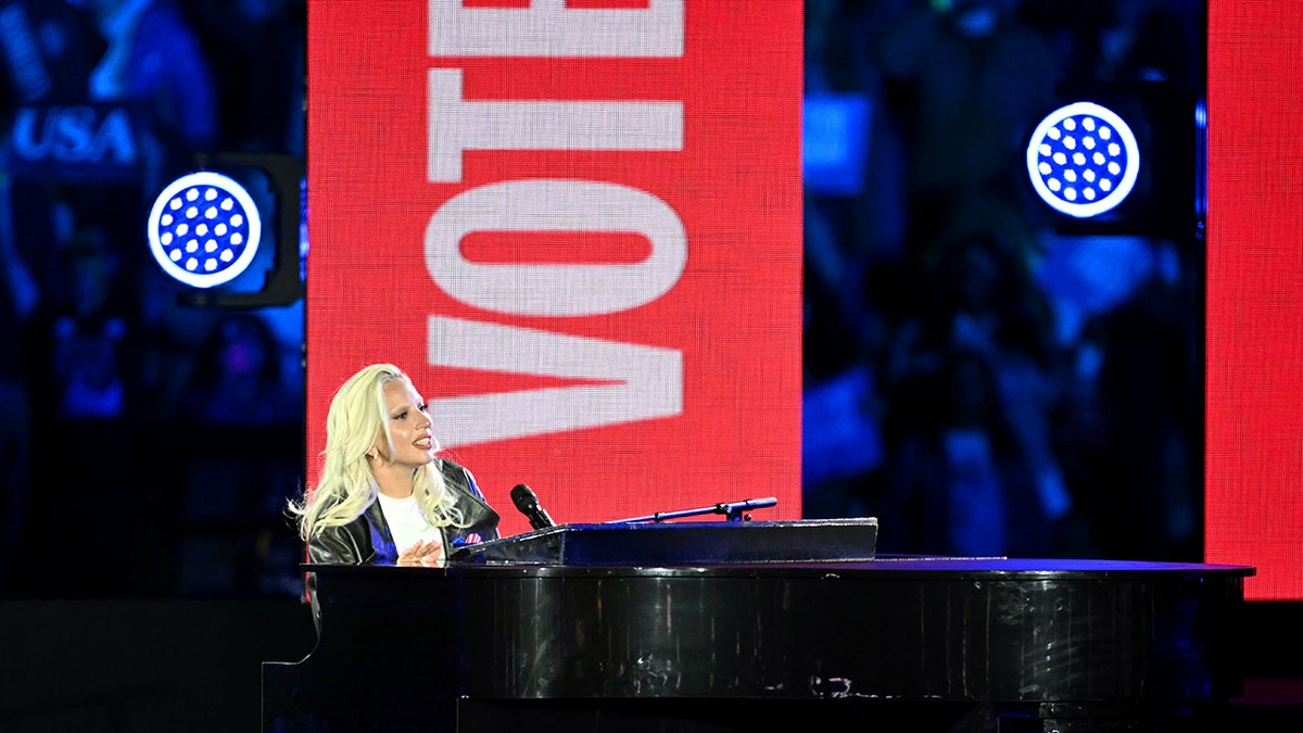 Lady Gaga palying a pinao at a Kamala Harris rally
