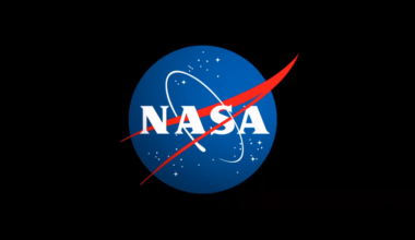 The letters NASA on a blue circle with red and white detail, all surrounded by a black background