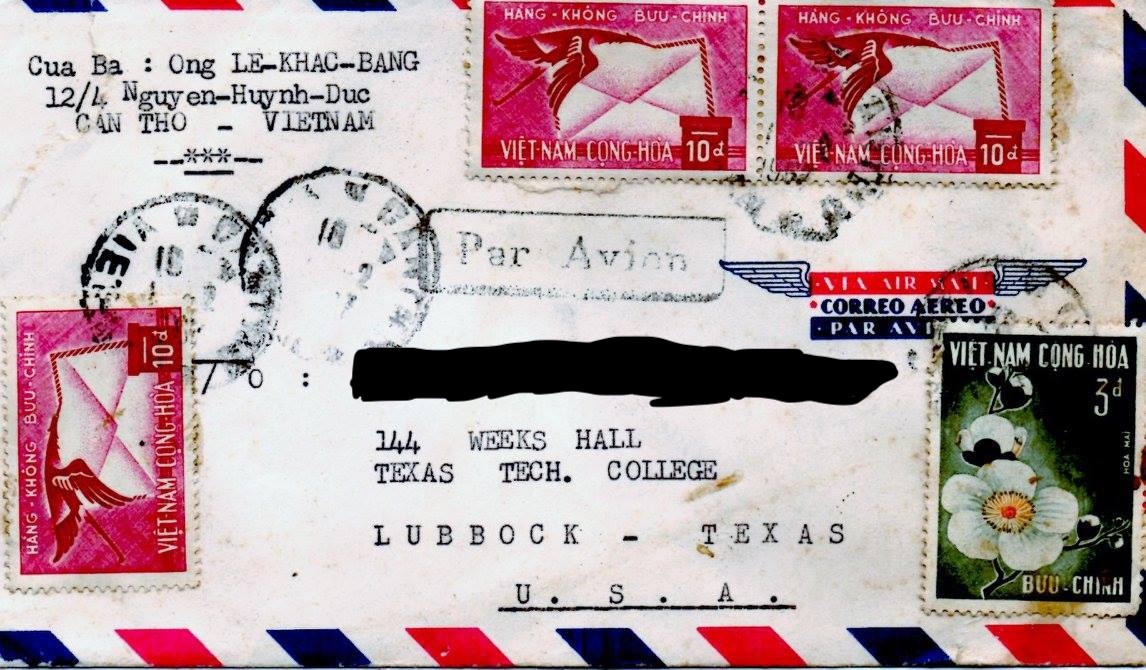 An airmail envelope with a red, white and blue striped border has a Lubbock, Texas destination typed on it, with a Vietnamese return address. Four Vietnamese stamps --three are hot pink while one is dark green with a white flower -- are on the edges of the enveloope