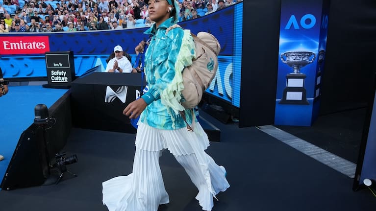 Naomi Osaka of Japan walks onto court for her second round match against Sorana Cirstea