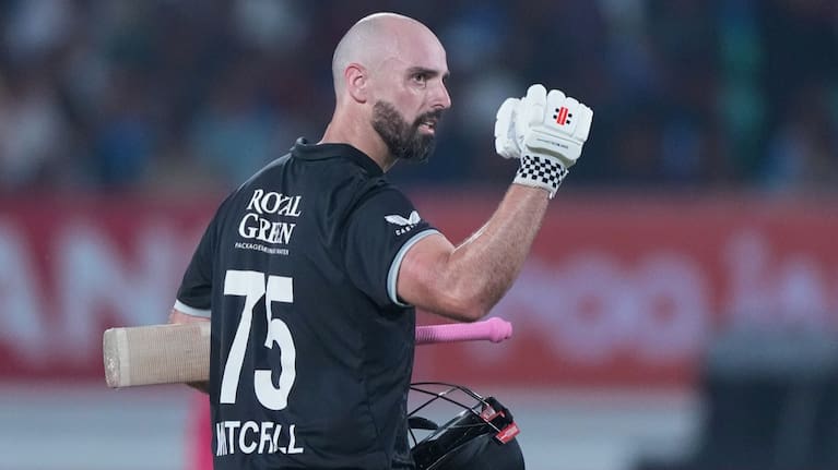 New Zealand's Daryl Mitchell celebrates after scoring a century during the second One Day International cricket match.