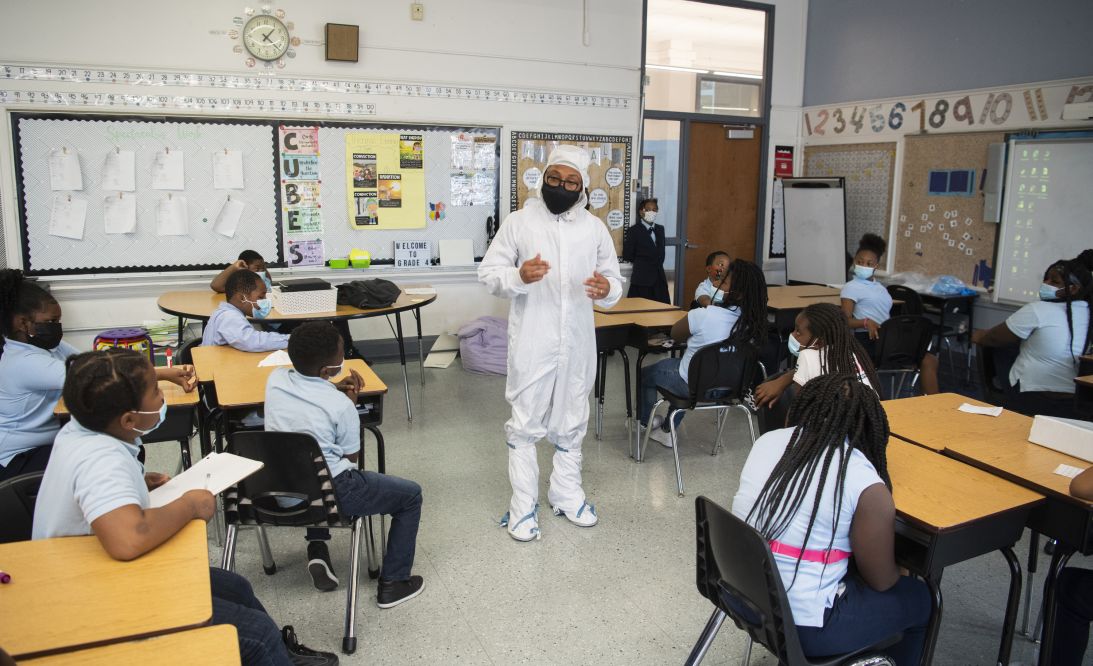 Kenneth Harris II is seen in a bunny suit, worn during spacecraft assembly to prevent contamination, as he speaks with students on November 18, 2021, at Garfield Elementary School in Washington, DC.