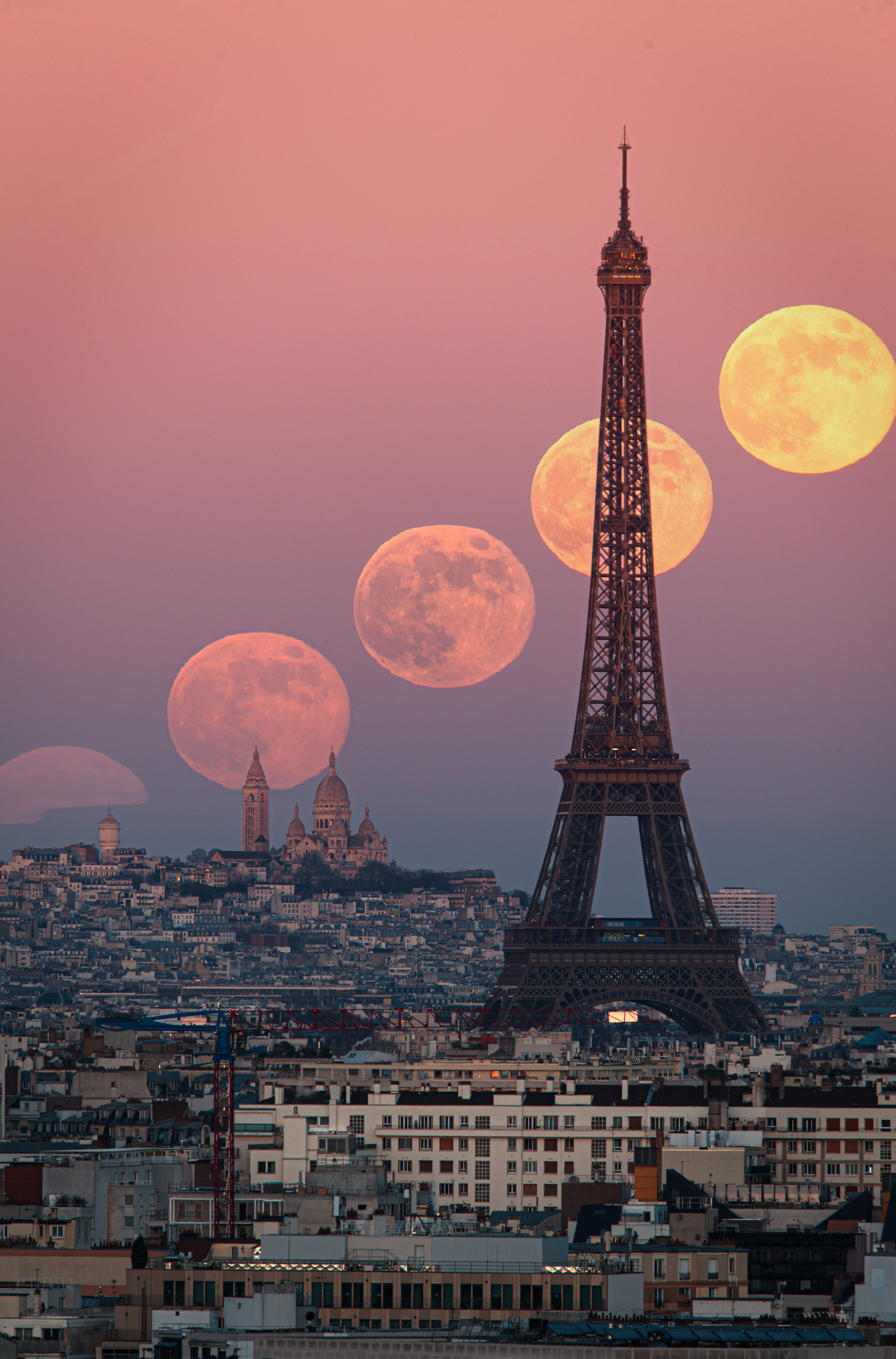 A series of full moons are pictured rising in a line above the Paris skyline. The Eiffel Tower dominates the center of the image, while a large domed church is visible on the skyline.