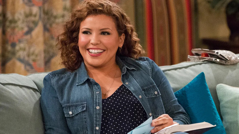 Penelope (Justina Machado) smiles at her family in One Day at a Time