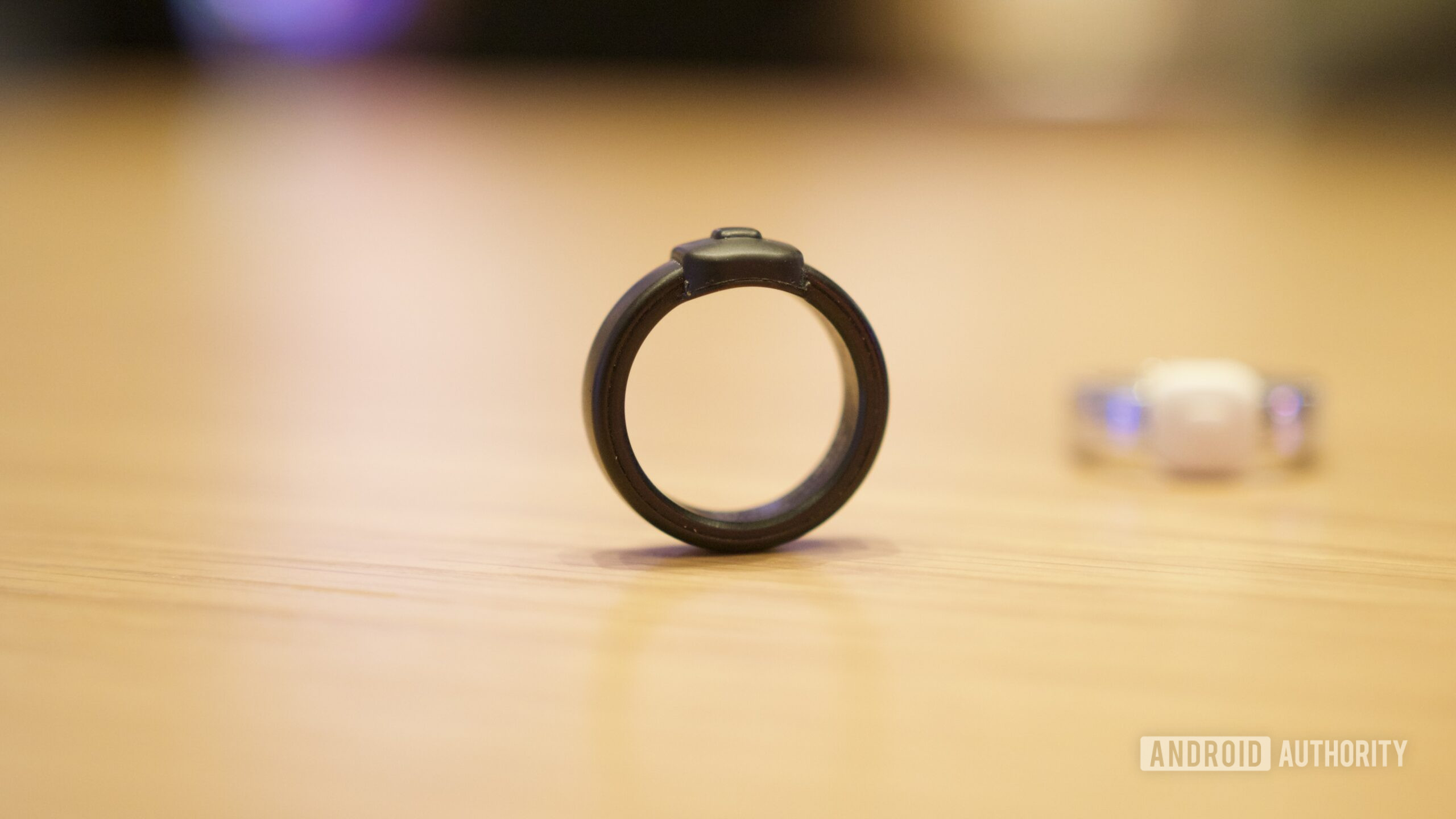 pebble index hands on ces 8 Pebble Index 01 ring sitting upright on a table.