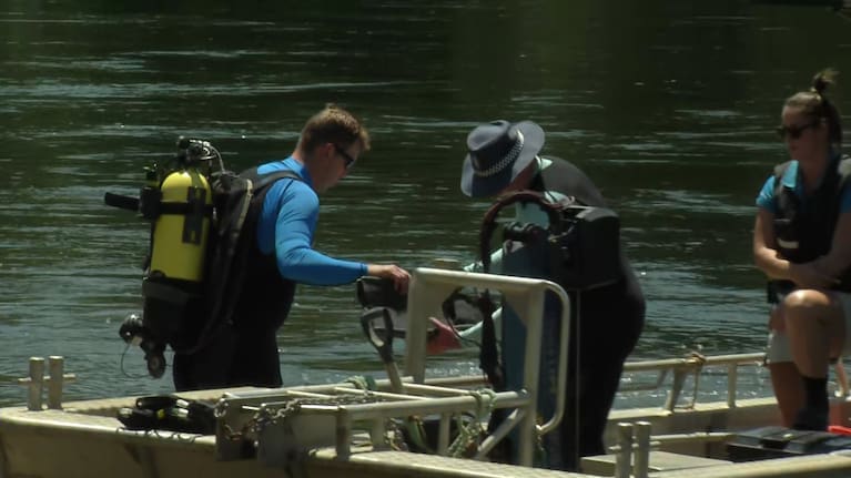 A diver prepares to search the Waikato River on Sunday.