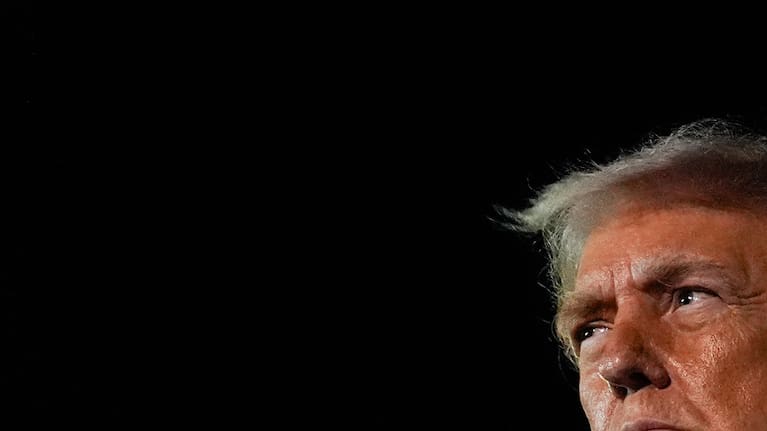 President Donald Trump speaks with reporters after arriving at Palm Beach International Airport.