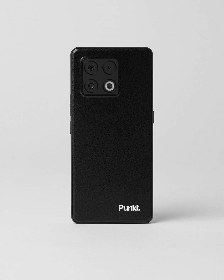 Photo of the Punkt MC03 smartphone showing a minimalist black rear shell with four camera lenses and the Punkt wordmark in white in the bottom right corner