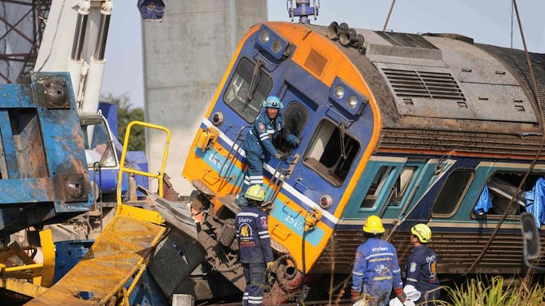 Rescuers work amidst the wreckage after a construction crane fell into a passenger train in Nakhon Ratchasima province, Thailand.
