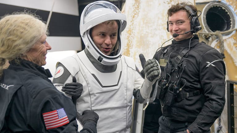 Roscosmos cosmonaut Oleg Platonov is helped out of the SpaceX Dragon Endeavour spacecraft.