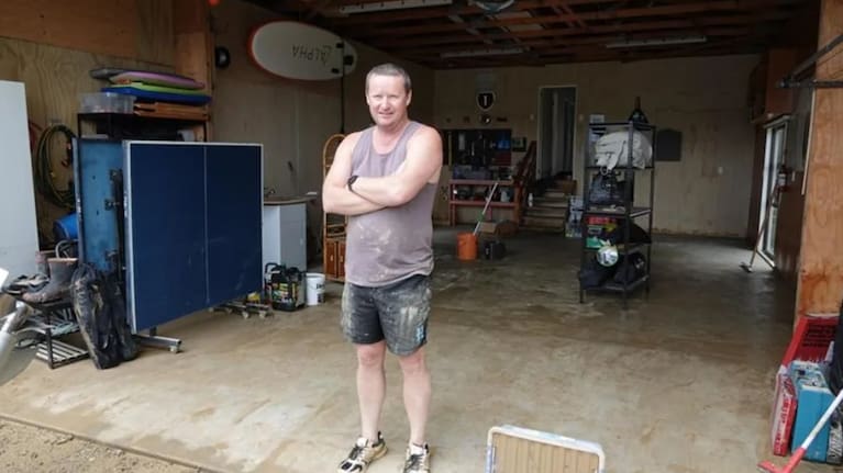 Shane McInnes in his garage. Photo: RNZ/Peter de Graaf