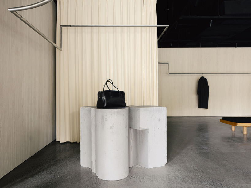 continuous steel rail traces shanghai showroom’s sculptural interior, like a freehand drawing