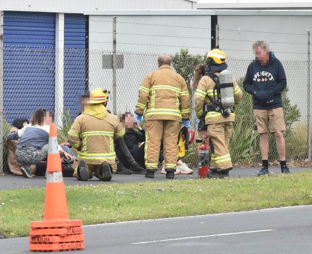 Firefighters check on the vehicles' occupants. PHOTO: GREGOR RICHARDSON