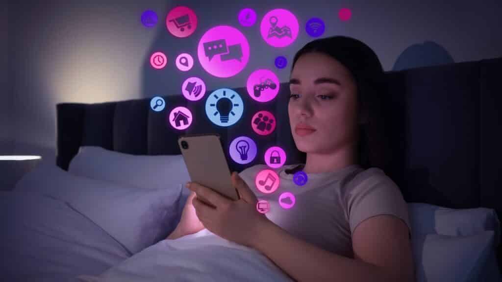 Internet addicted woman using mobile phone instead of sleeping at night.