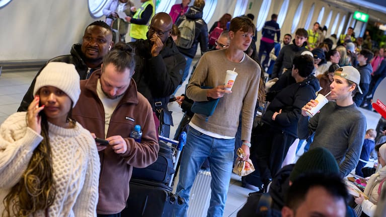 Stranded travellers queue at the information desk at Schiphol airport in Amsterdam, Netherlands.