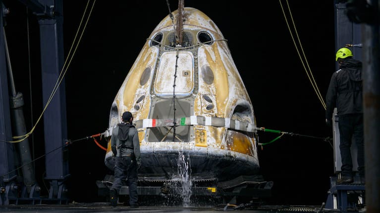 Support teams onboard the SpaceX recovery ship SHANNON work around the SpaceX Dragon Endeavour spacecraft.