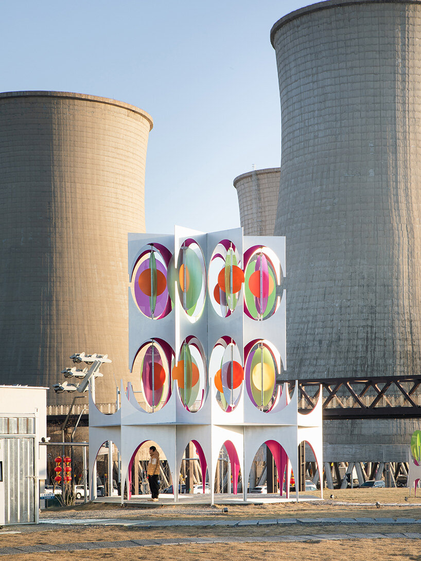 suspended colored discs move through daxing jizi design's faceted installation in beijing