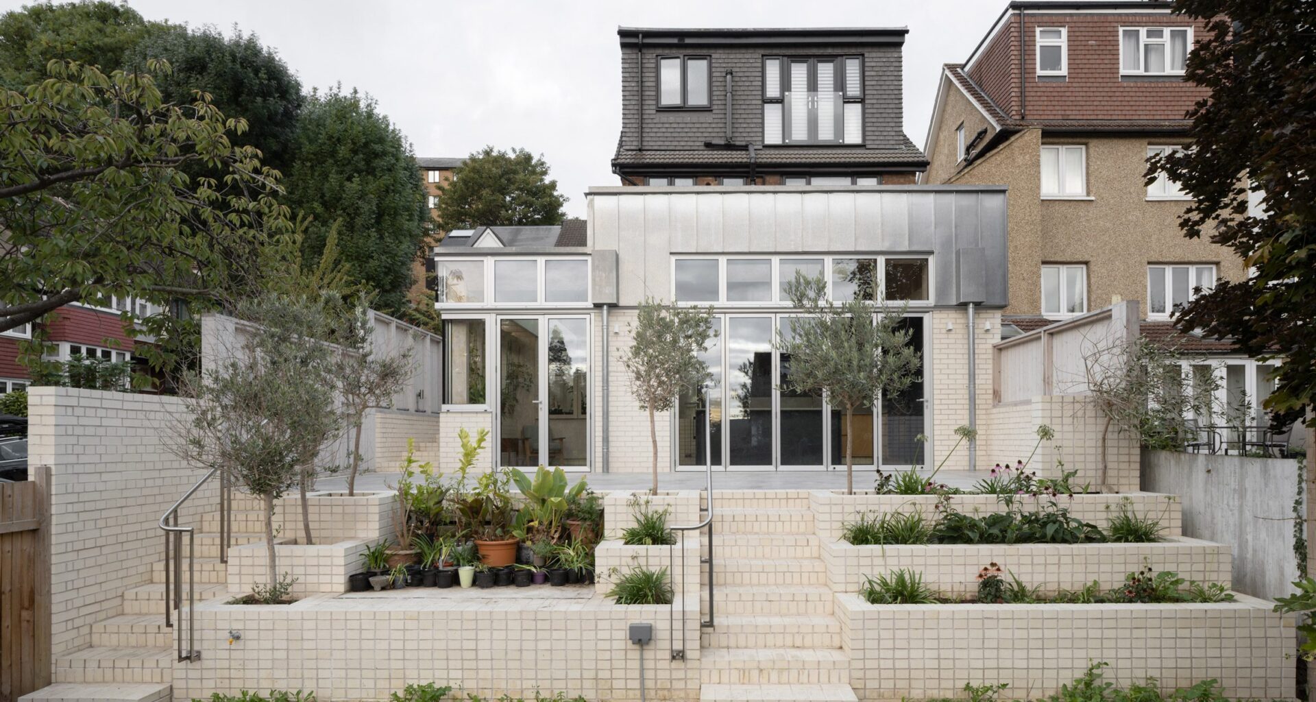 Zinc and white brick rear facade of Tabberner Cook House by James Alder Architects