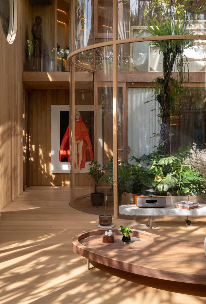 curved glass atriums penetrate residence’s aluminum roof in bangkok