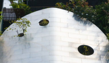 glass atriums penetrate bangkok residence’s aluminum roof