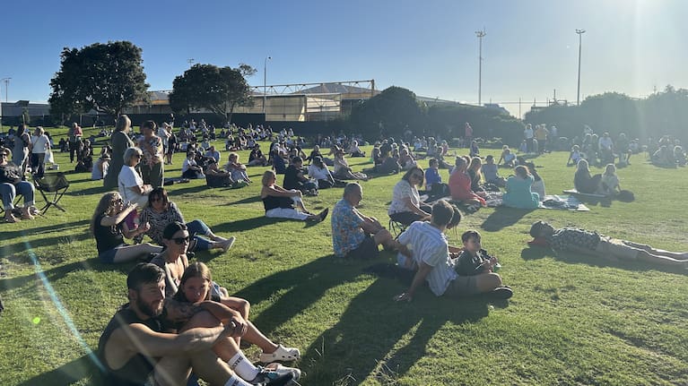 The Mount Maunganui community gathers for a vigil honouring the victims of the landslides in Tauranga.