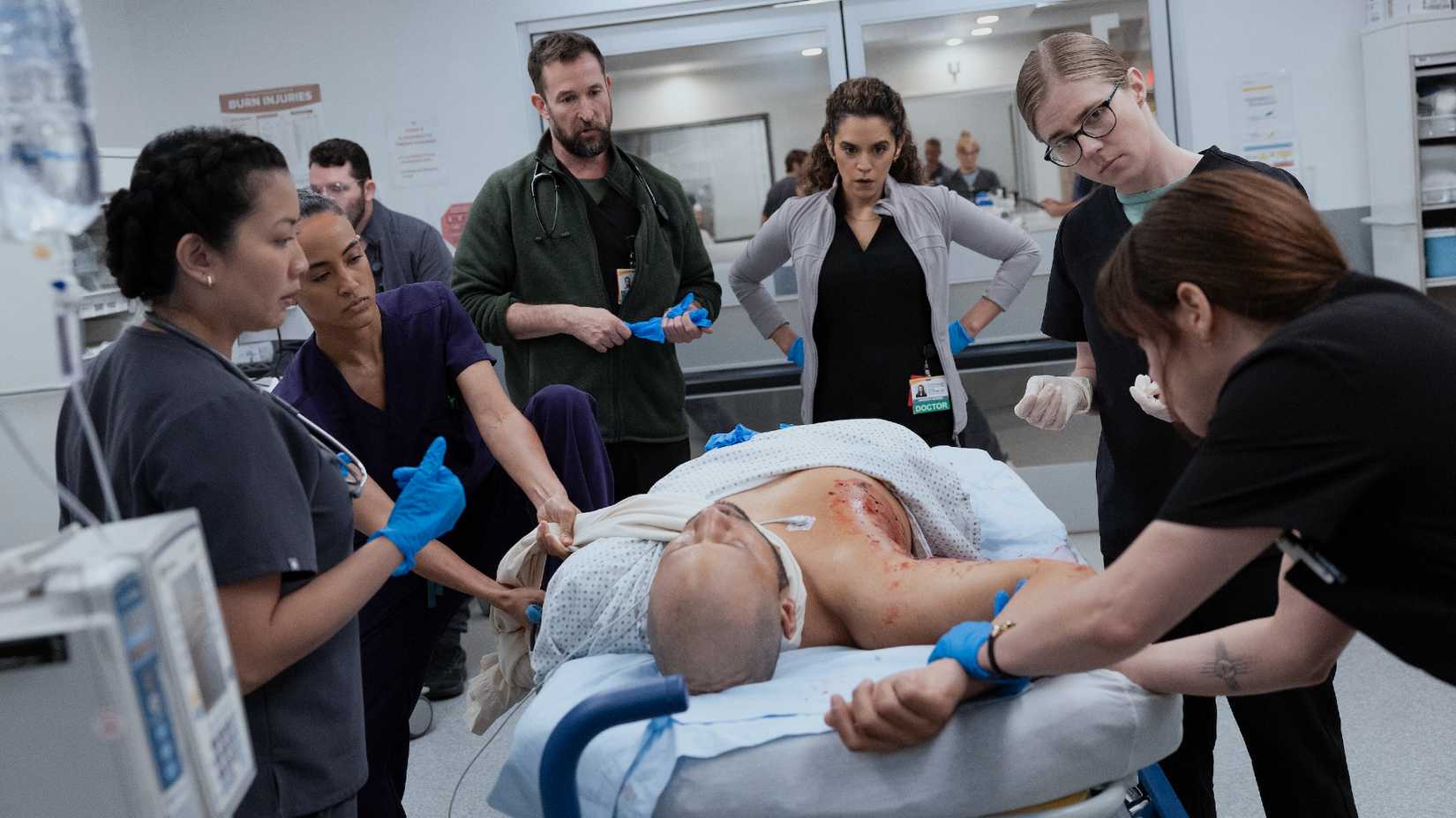 Nurse Princess, Dr. Garcia, Dr. Robby, Dr. Al-Hashimi, Dr. King, and Dr. McKay Standing Around a Patient in The Pitt Season 2