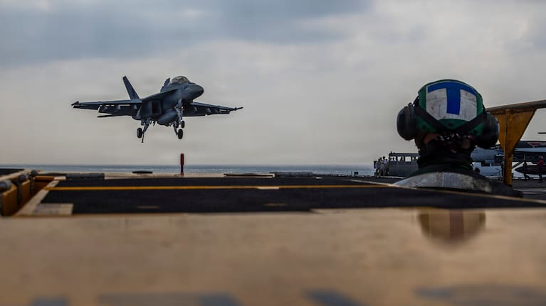 This photo provided by the U.S. Navy shows a Boeing F/A-18E Super Hornet landing on the Nimitz-class aircraft carrier USS Abraham Lincoln in the Indian Ocean.