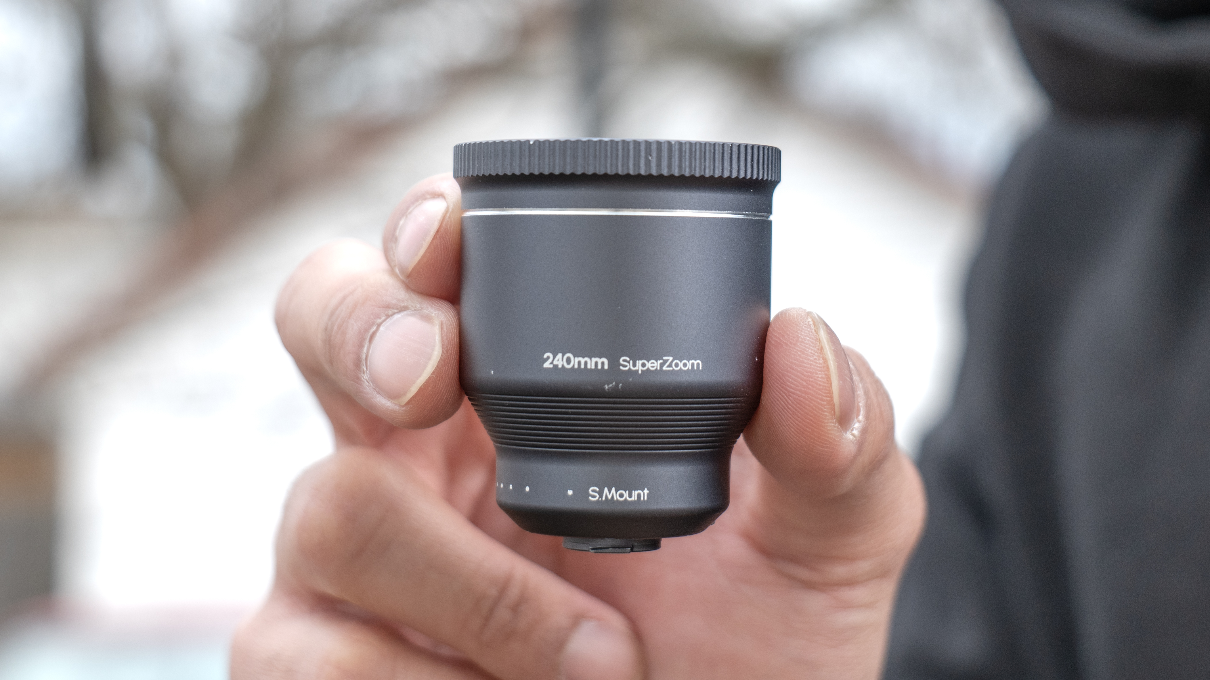 Shiftcam 240mm Super Zoom Tele Lens held in the hand.