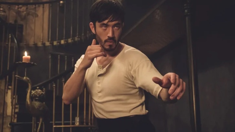 Ah Sahm (Andrew Koji) in a fighting stance in Warrior