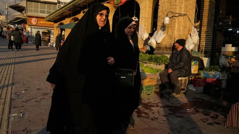 Women walk past the Tajrish bazaar in northern Tehran, Iran.