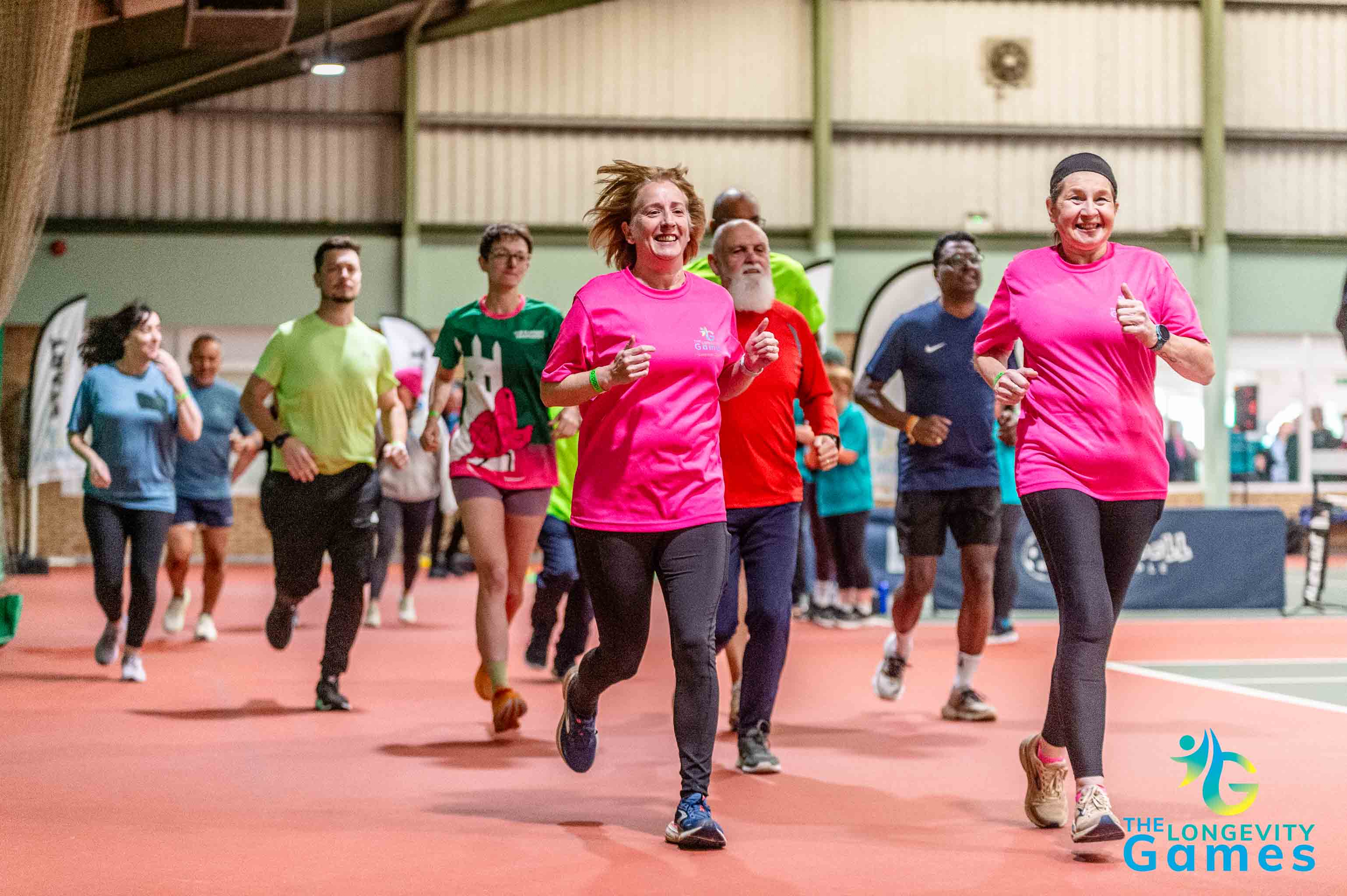 Competitors at The Longevity Games running indoors.