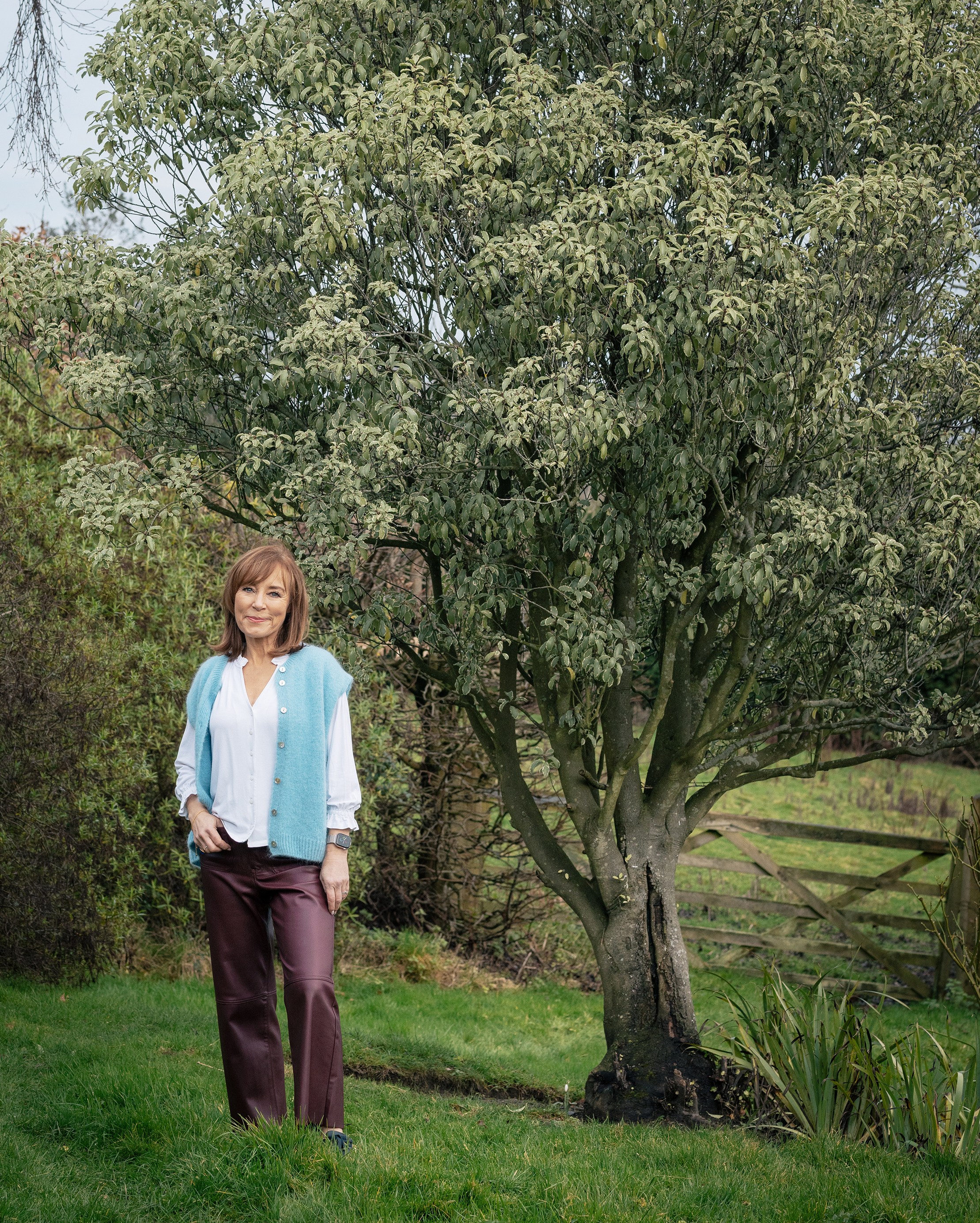 Sian Williams standing in a garden.