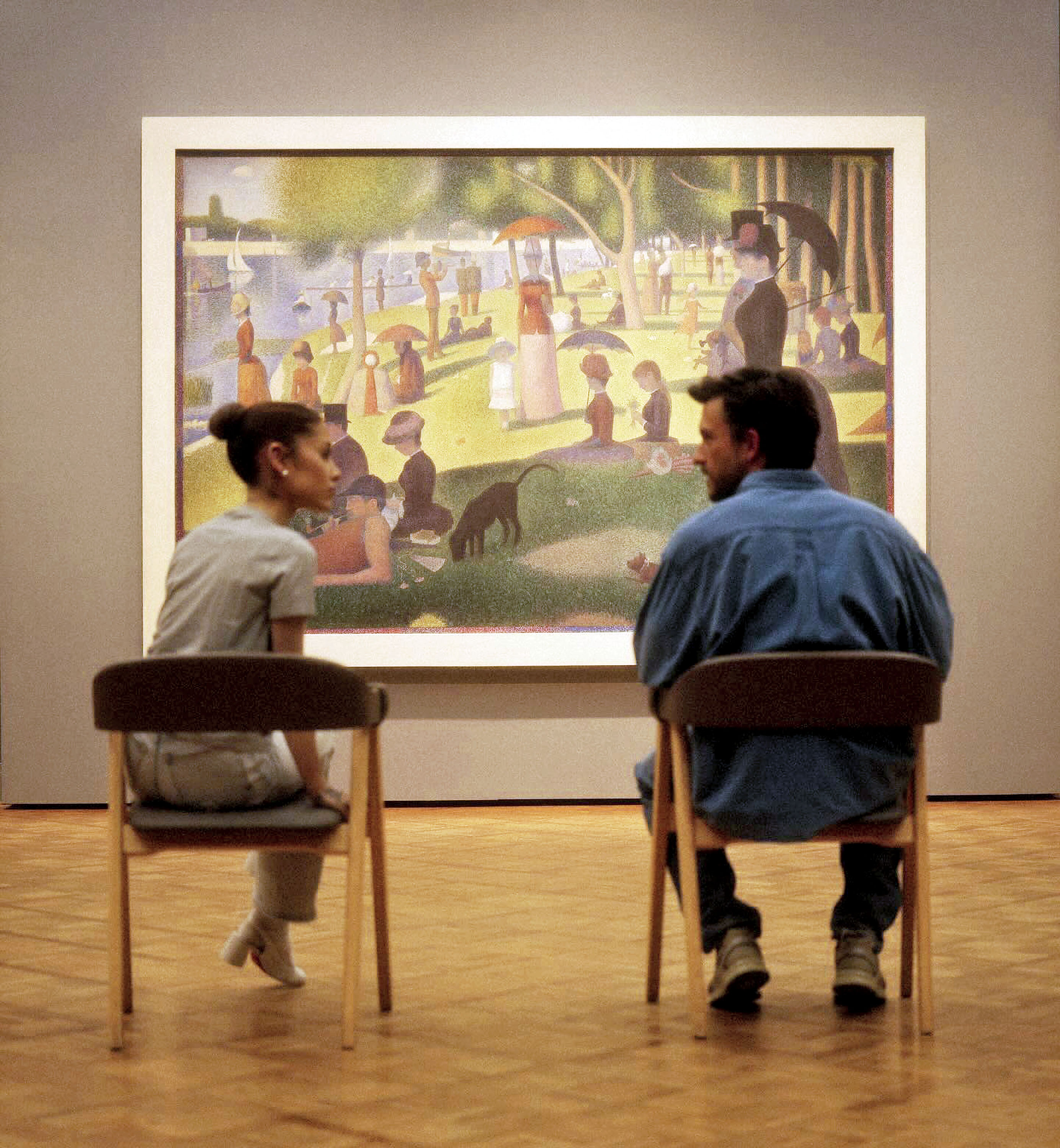 Ariana Grande and Jonathan Bailey sitting in front of Georges Seurat's painting.