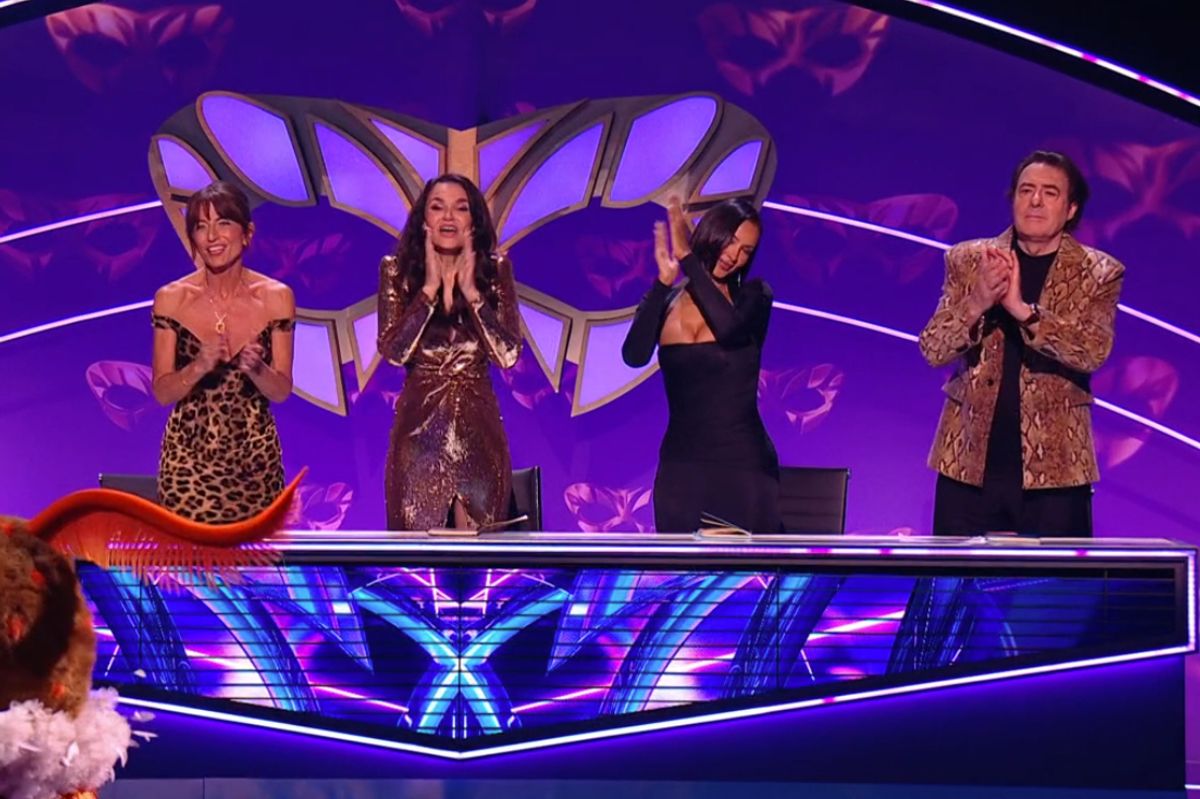 Moth being congratulated by the Masked Singer judges