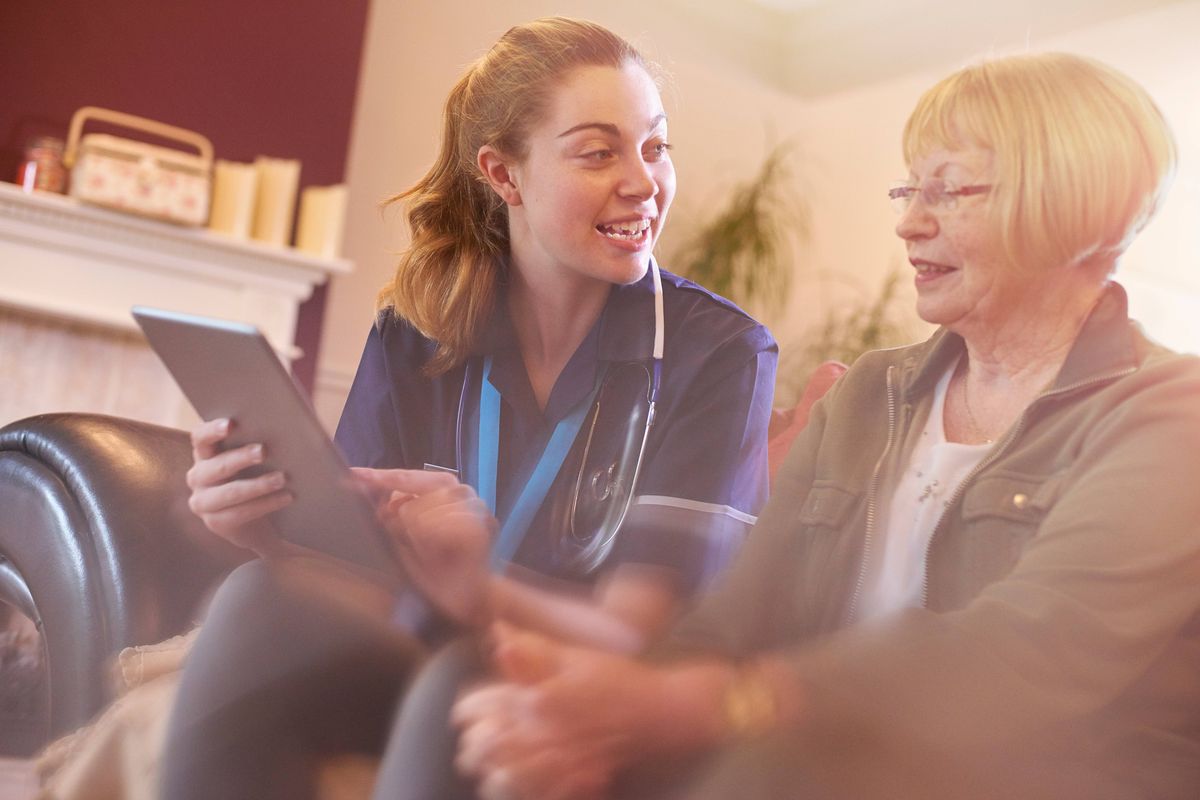 nurse comes to see senior patient