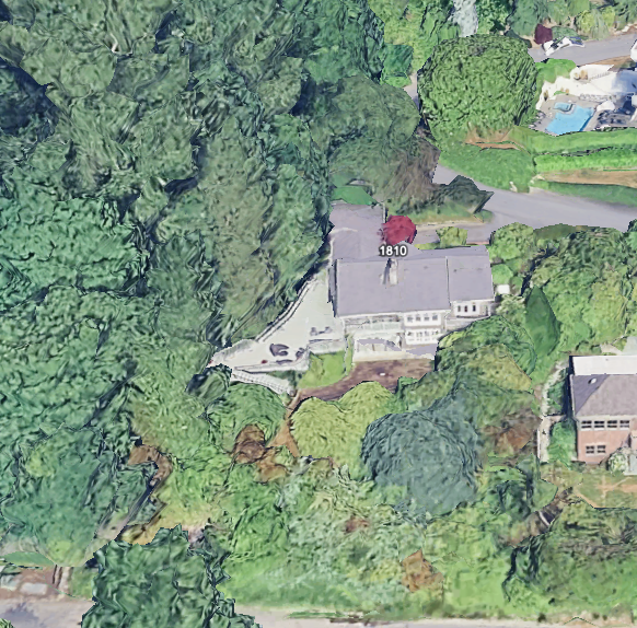 Aerial view of a residential property surrounded by greenery.
