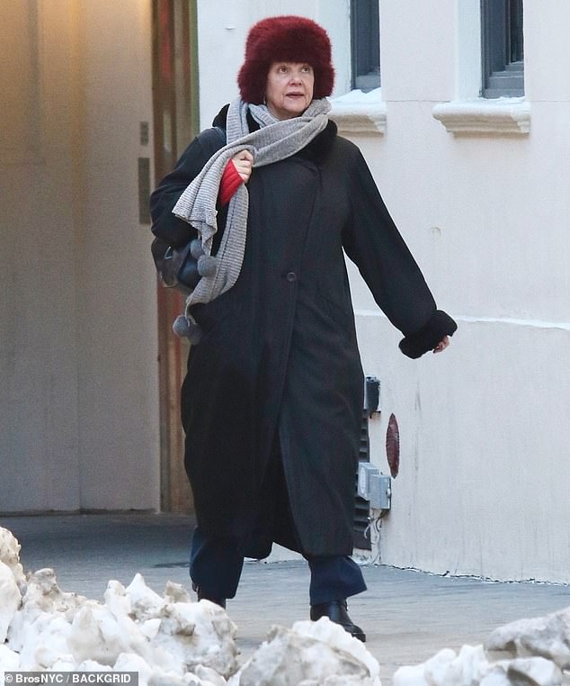 The star was seen in a black coat, red fur hat, gray scarf and sensible black boots as she raved the cold weather on the snow-lined streets of New York City on Monday