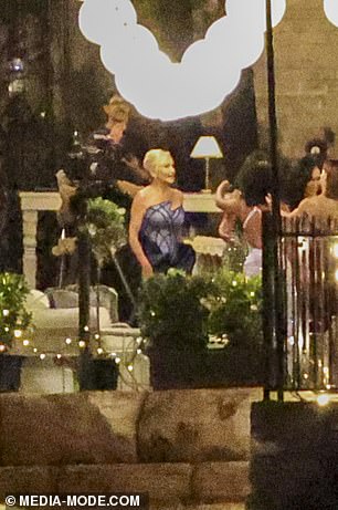 Women cast members in evening wear gather on one of the terraces at Tresco, the $115m harbourfront mansion