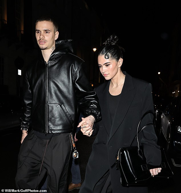 The couple held hands as they left the Indian restaurant
