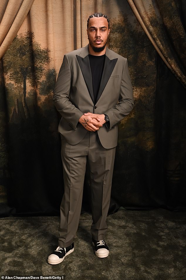 AJ Tracey looked suave in a khaki green suit which she paired with black trainers