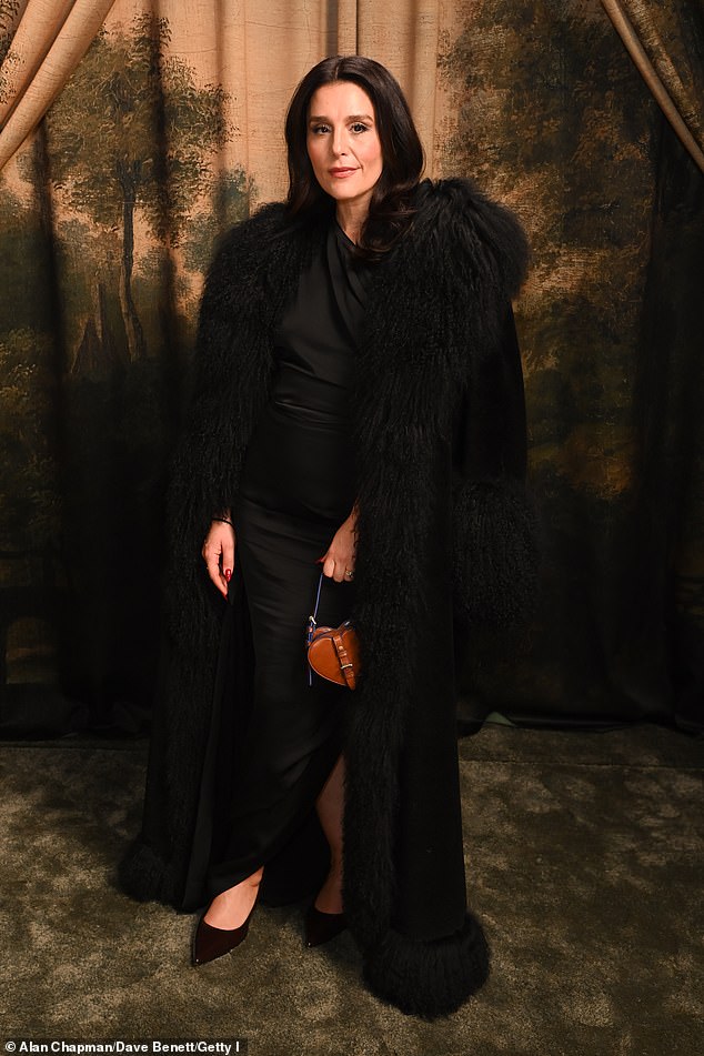 Jessie Ware kept it simple in a fitted black dress and feathered black coat