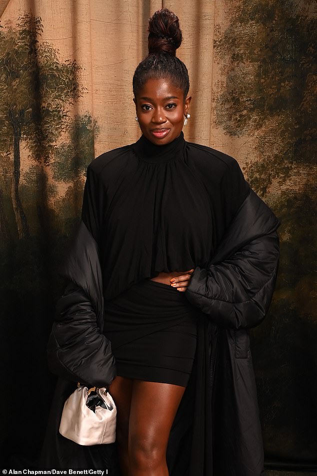 Clara Amfo put on a leggy display as she wowed in a black two piece before wrapping up in a large padded black coat