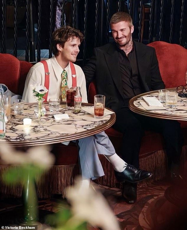 David look prouder than ever as he chatted away to musician Cruz during the bash