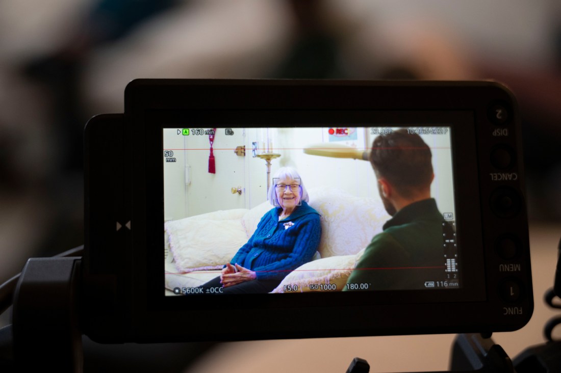 Ruth Gove and her interviewer in a camera's viewfinder.