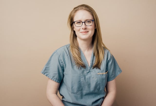 A woman in medical scrubs