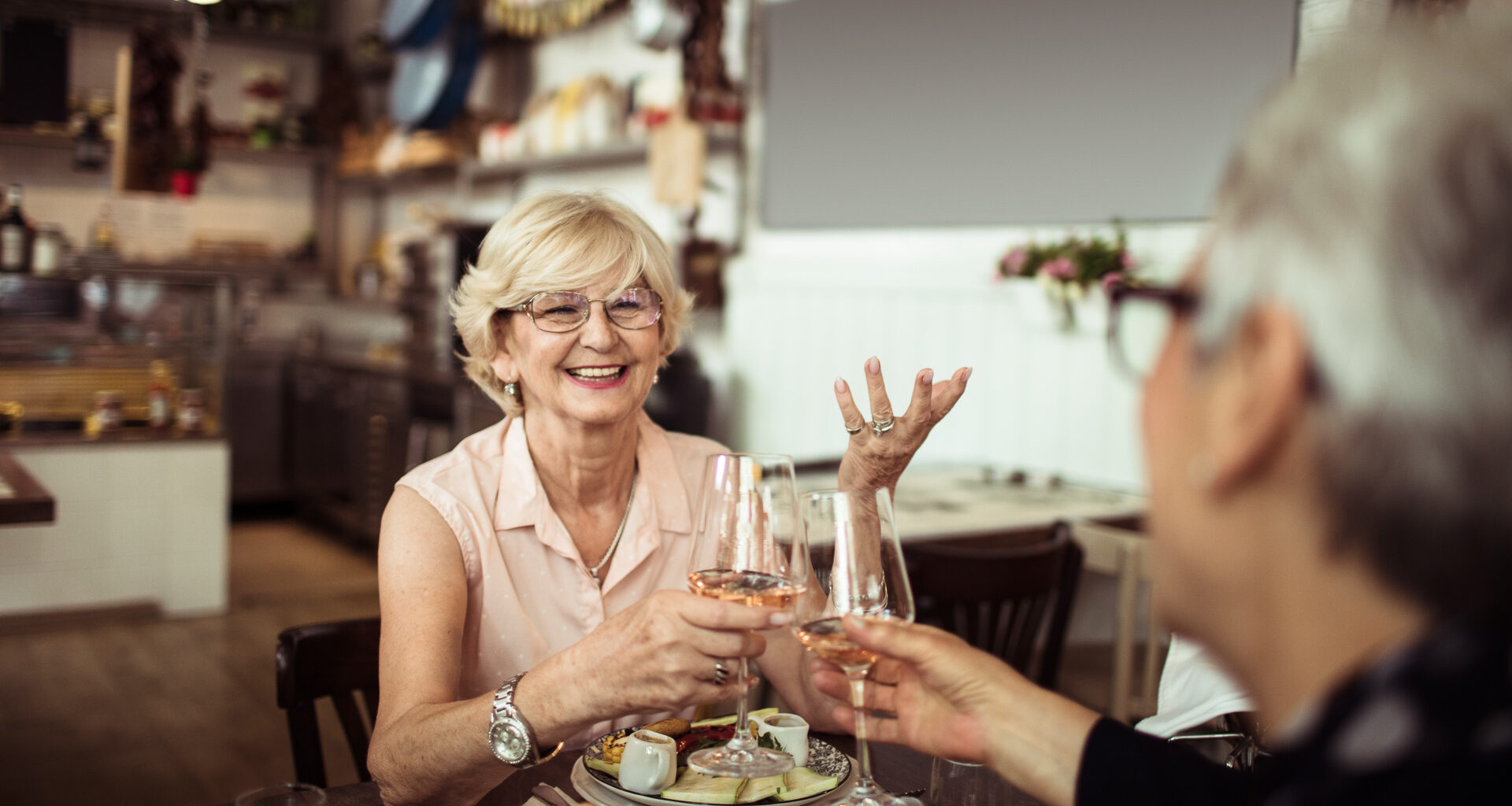 Close up of two senior friends having brunch in a local restaurant.