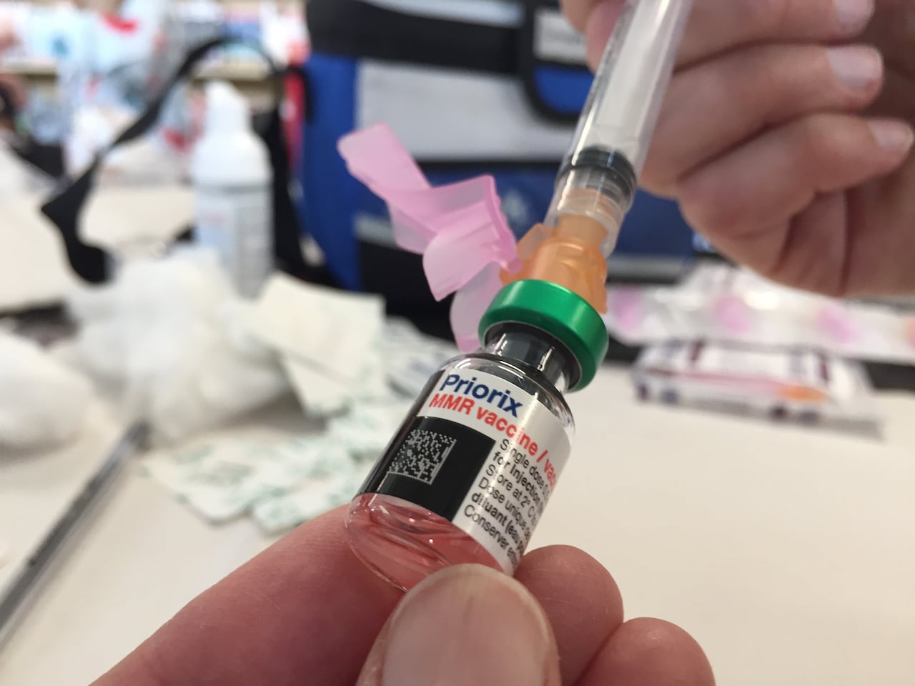 A closeup shot of an MMR vaccine needle being filled.