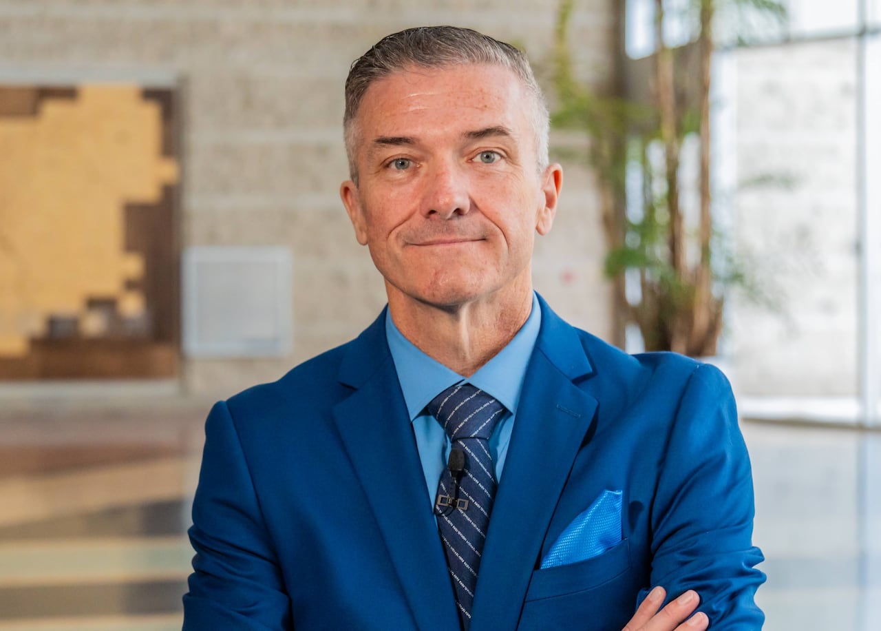 A man in a blue suit and tie.