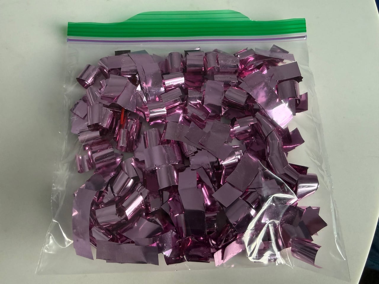 A small Ziplock bag filled with pink confetti.