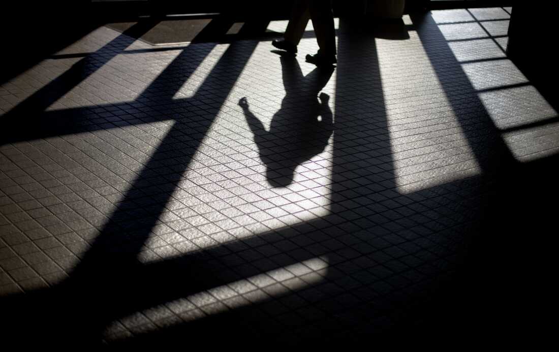 In this 2012 photo, the shadow of a Georgia Department of Juvenile Justice correctional officer is cast as he leaves a training facility.